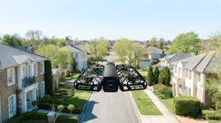 HOVERAir X1 PROMAX hovering in mid-air over a suburban street