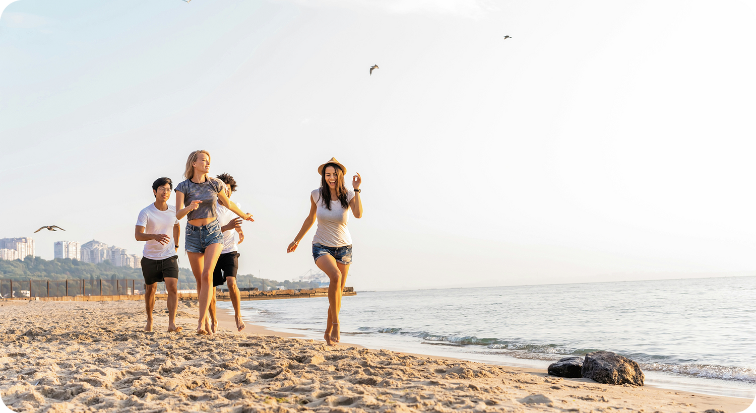Friends running on a sunny beach