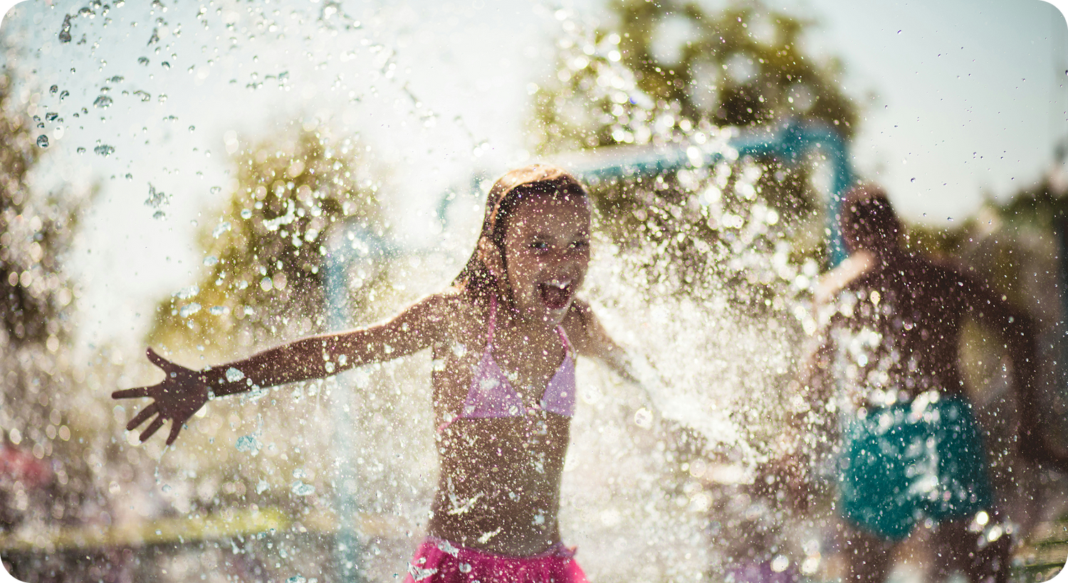 Girl playing in water splash