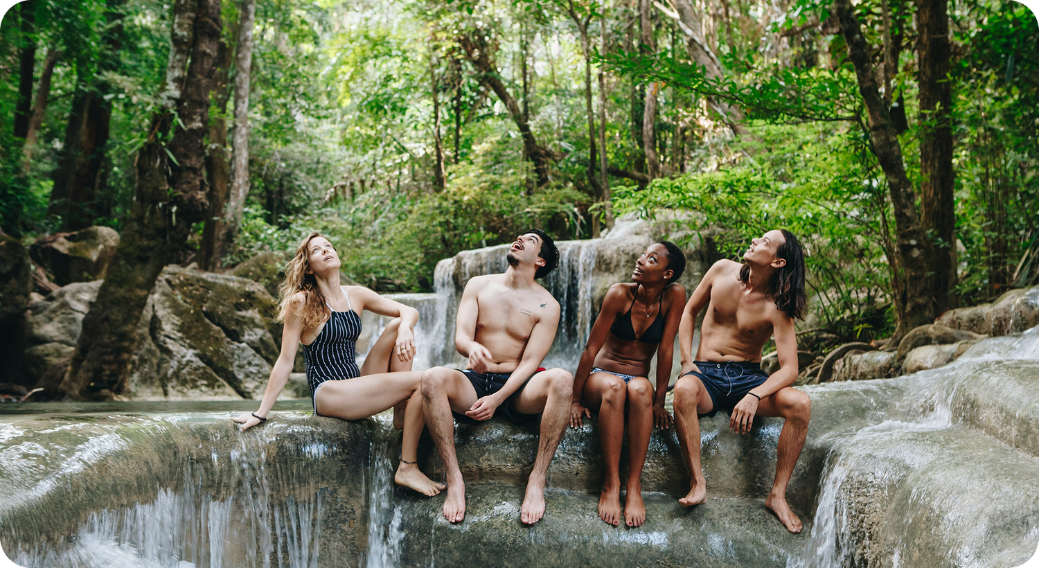 Group sitting at a jungle waterfall