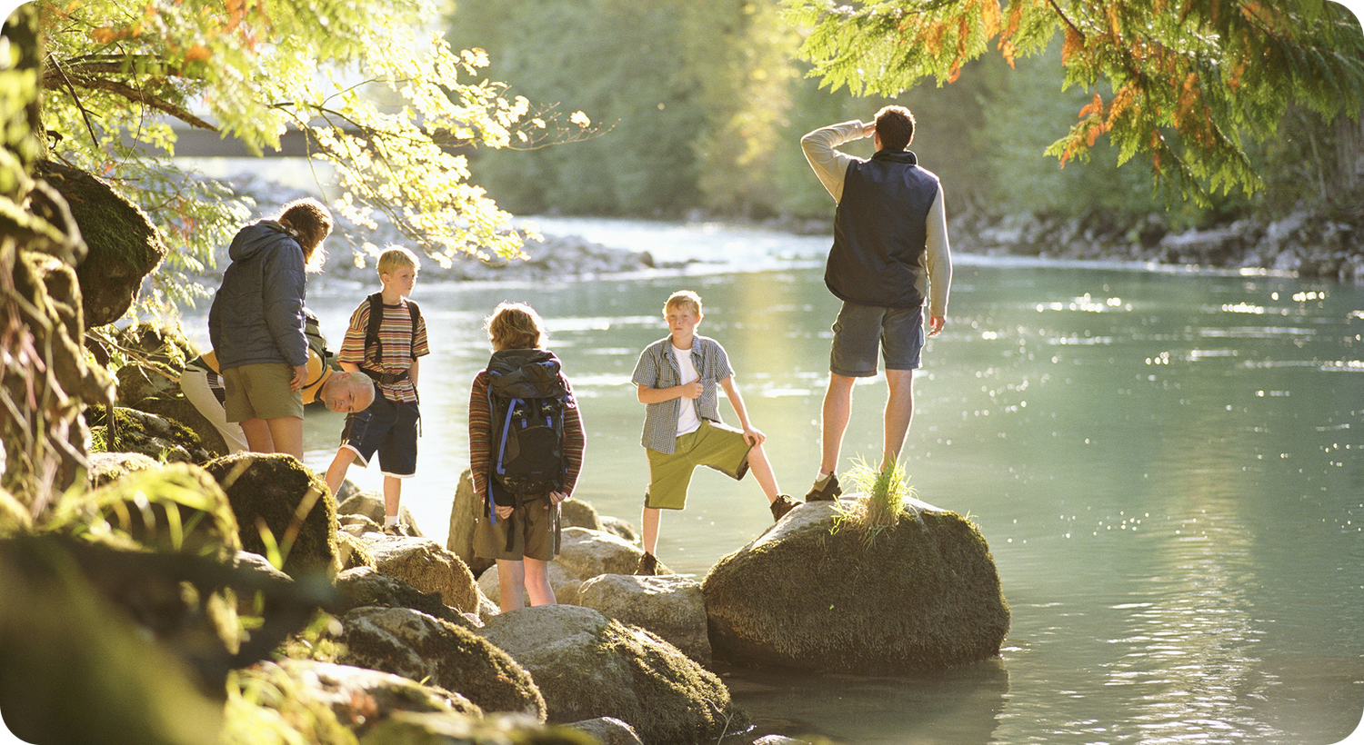 Kids hiking near a river in the forest